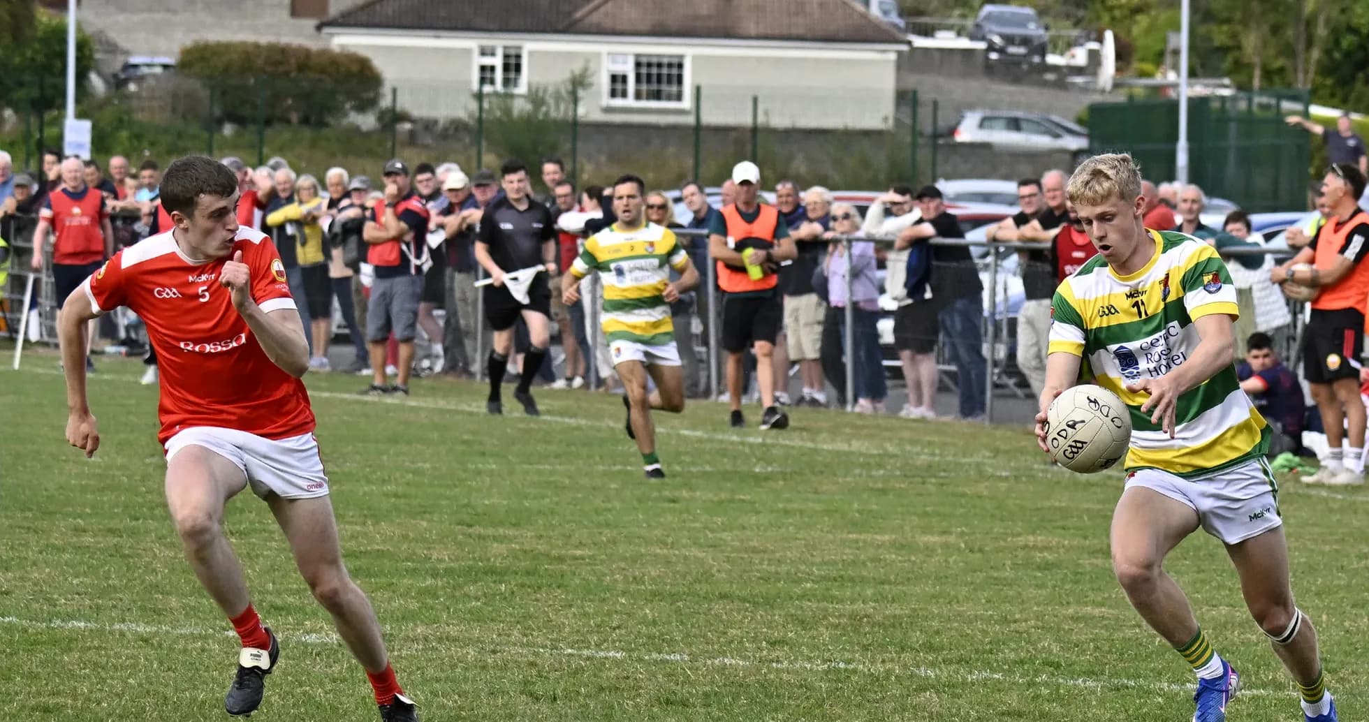 Player in green and yellow jersey controlling ball