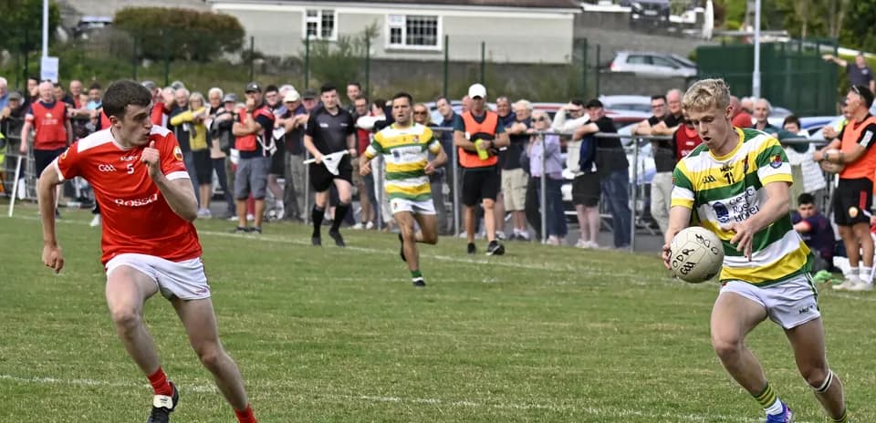 Player in green and yellow jersey controlling ball
