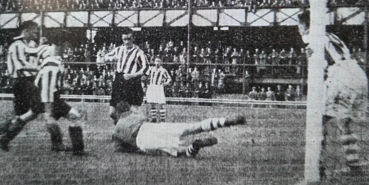 Players contesting near goal during historic match