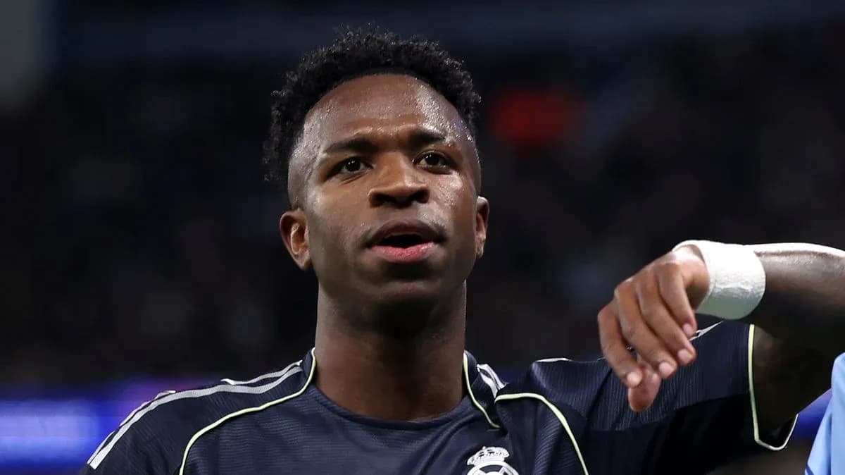 Player gesturing during match wearing Real Madrid kit