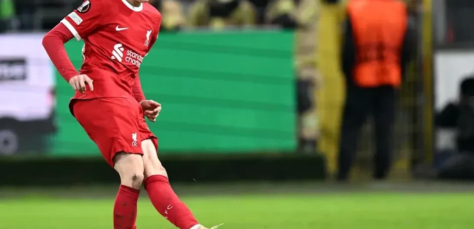 Player in red kit kicking ball during match