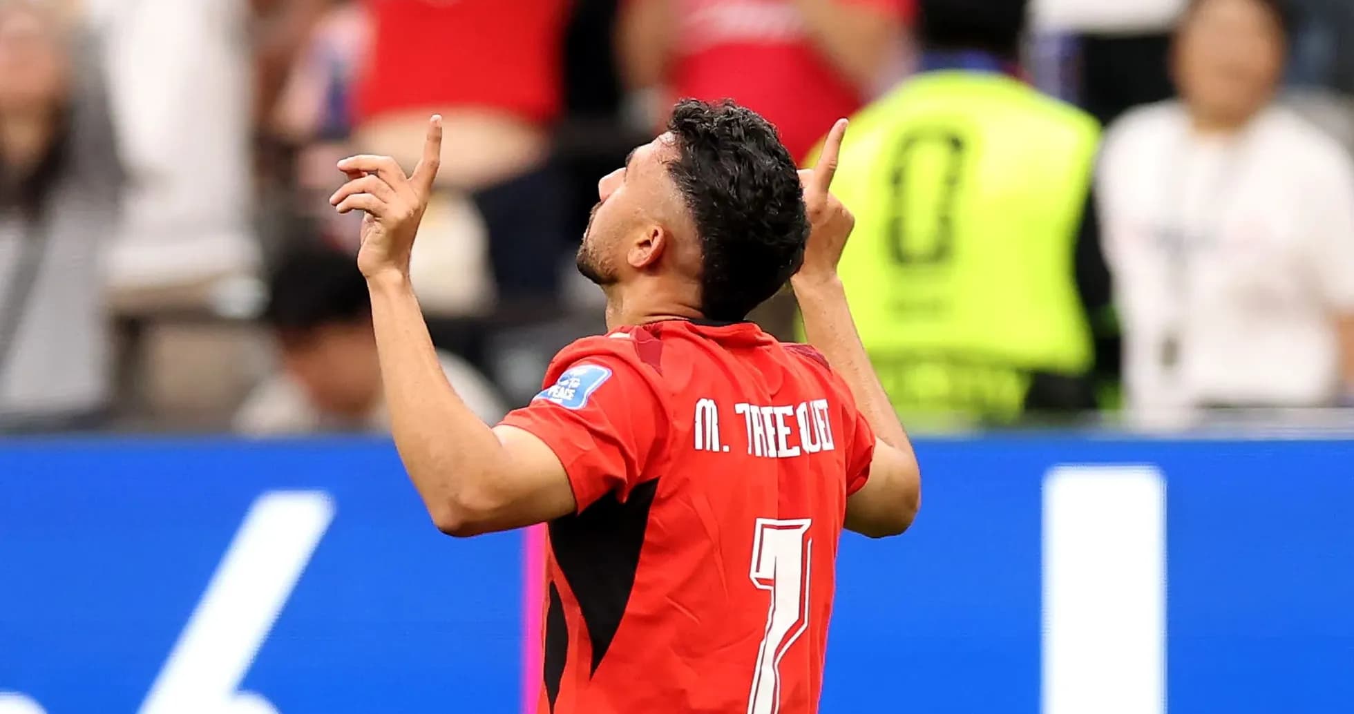 Player celebrating with arms raised after scoring
