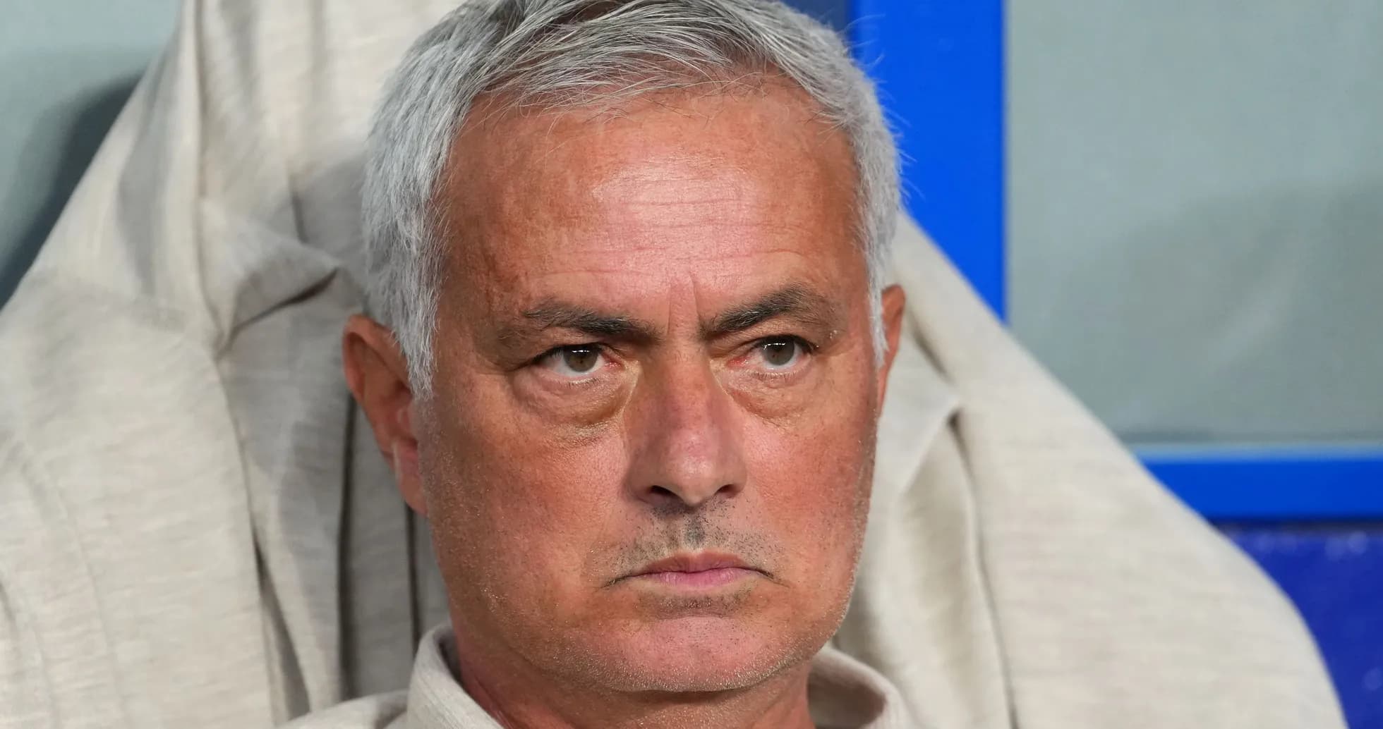 Coach sitting on bench during a match