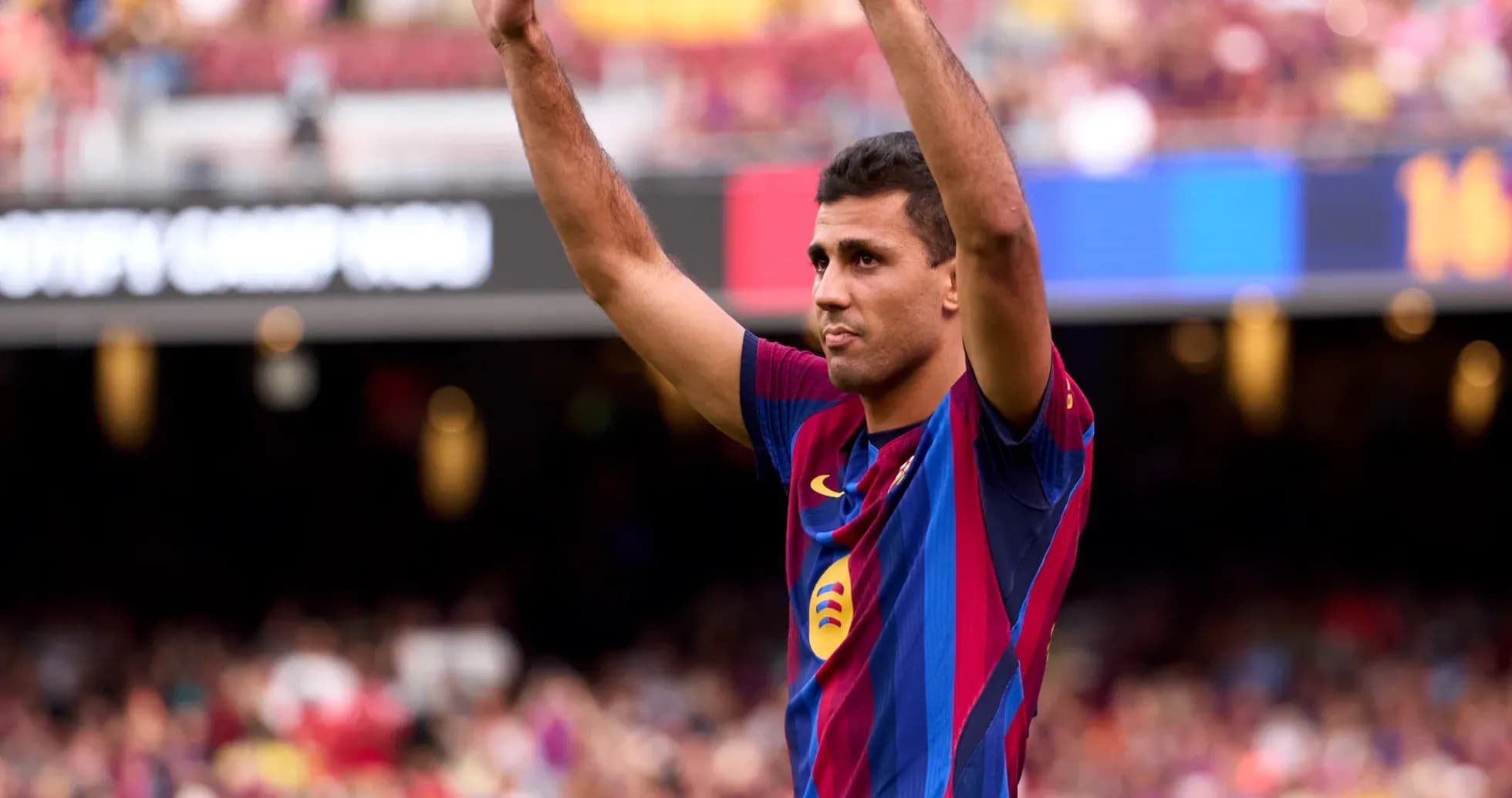 Player celebrating with raised arms at Camp Nou