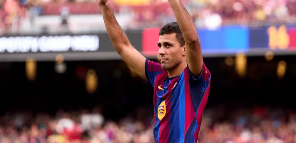 Player celebrating with raised arms at Camp Nou