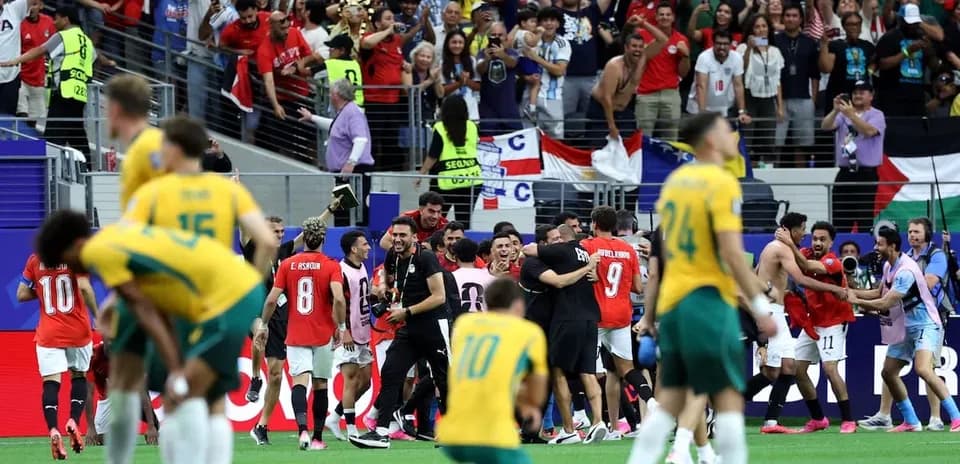 Players celebrating victory with fans in the stadium