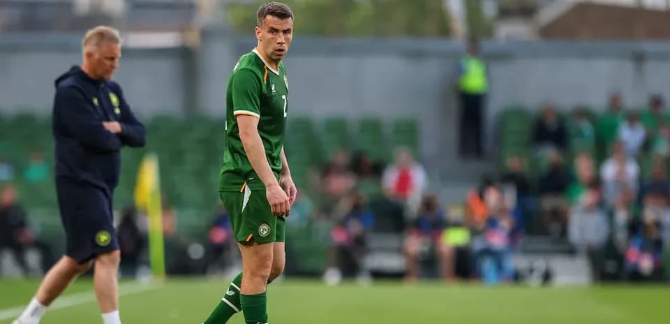 Player in green jersey on the pitch during match