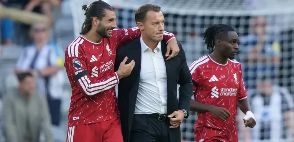Liverpool players celebrating with their manager on field