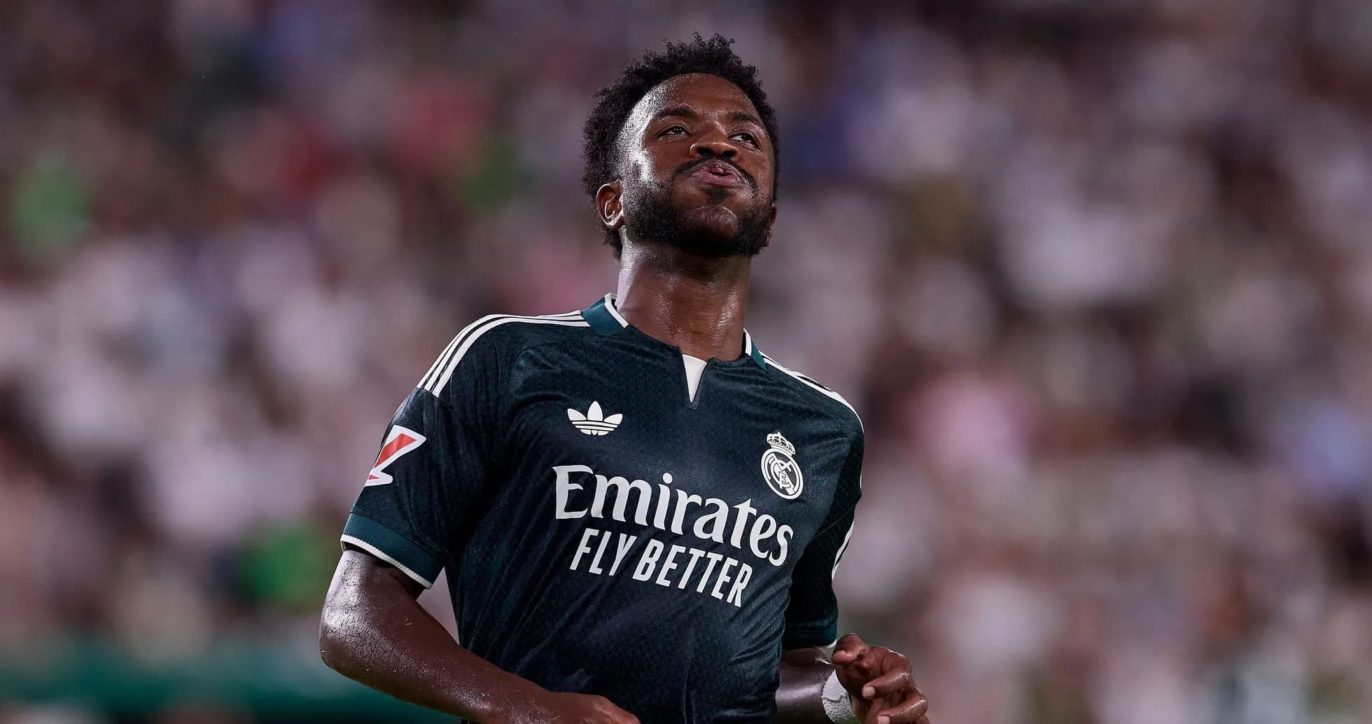 Player in Real Madrid jersey on the pitch