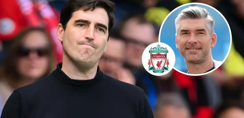 Coach looking on with Liverpool logo in corner