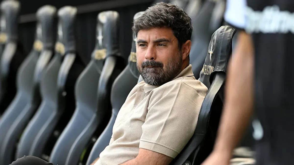 Coach sitting on bench during match preparations