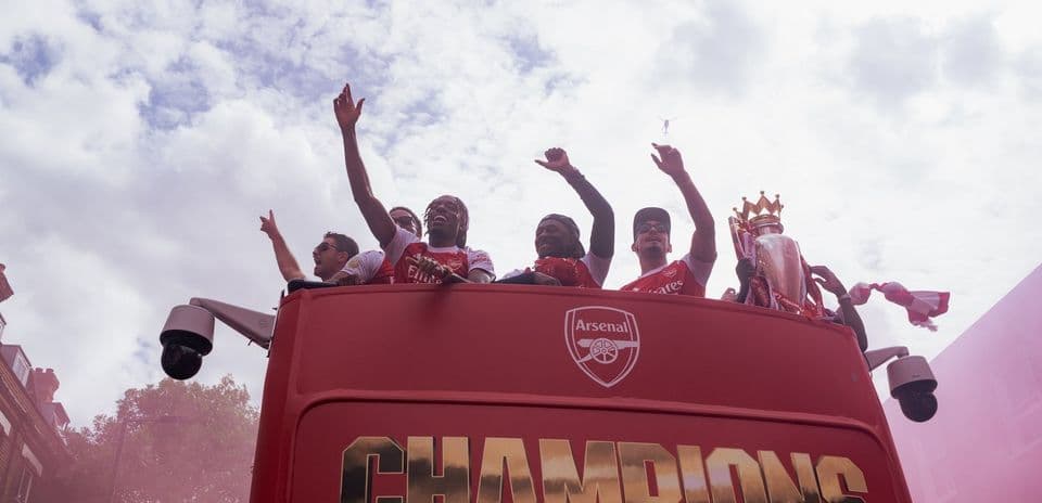 Arsenal players celebrating on open-top bus parade