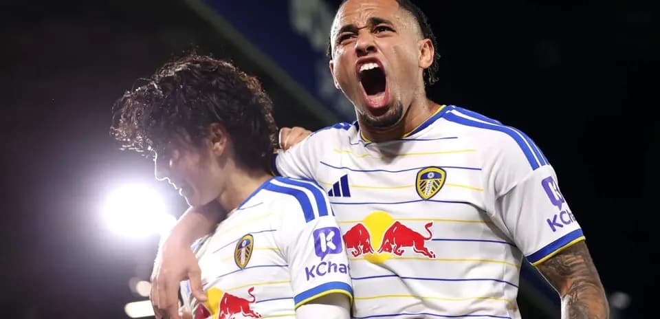 Leeds United players celebrating a goal on pitch
