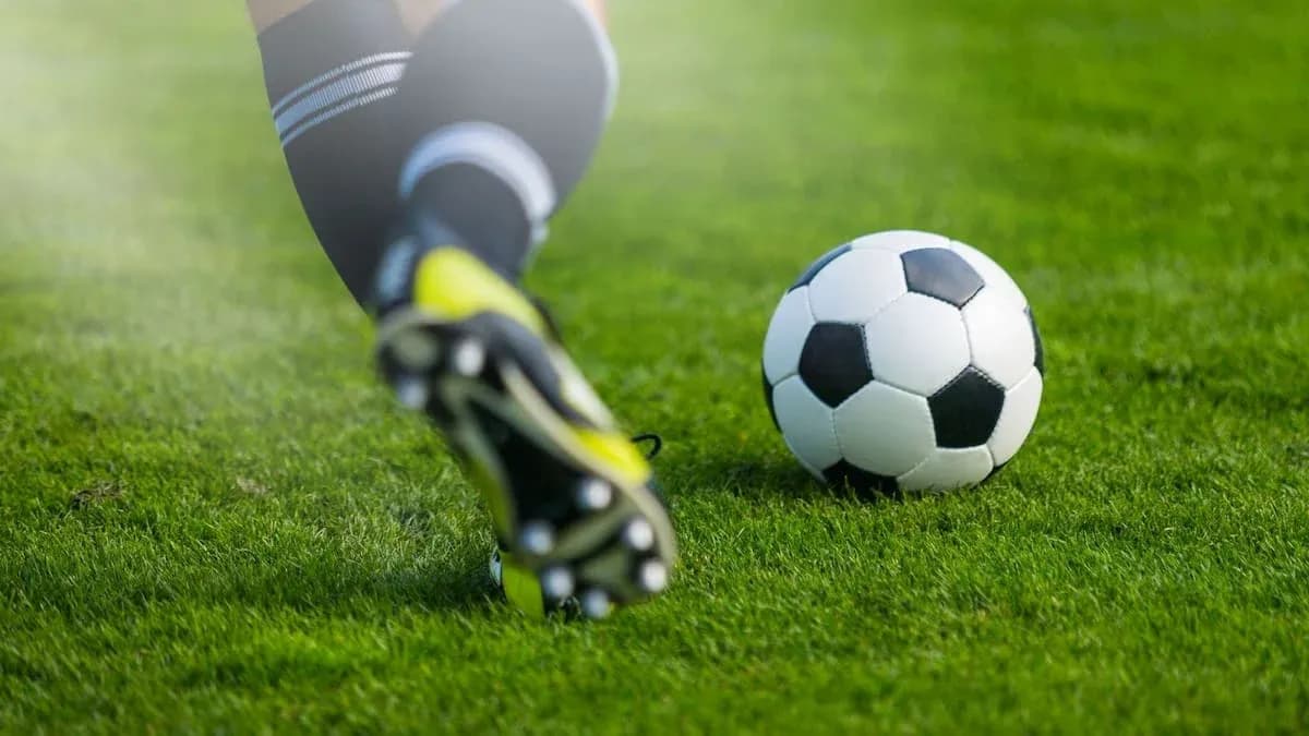 Player kicking a soccer ball on the field