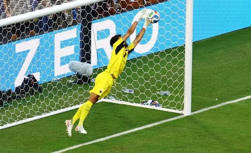 Goalkeeper diving to save a shot on goal