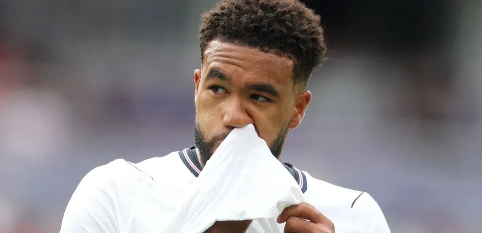 Player holding jersey to face during match