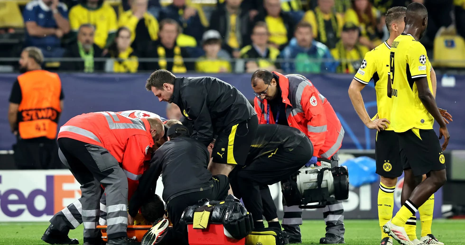 Medical staff attending to injured player on pitch