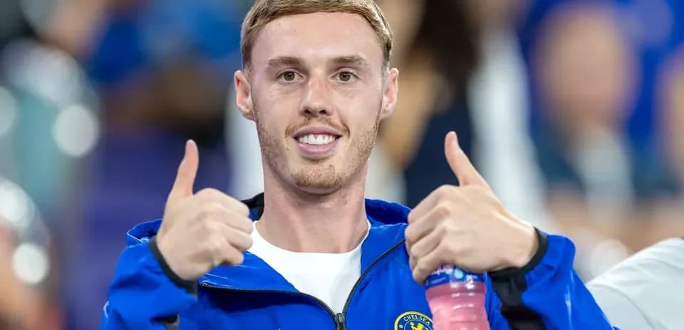 Player giving thumbs up in team jacket
