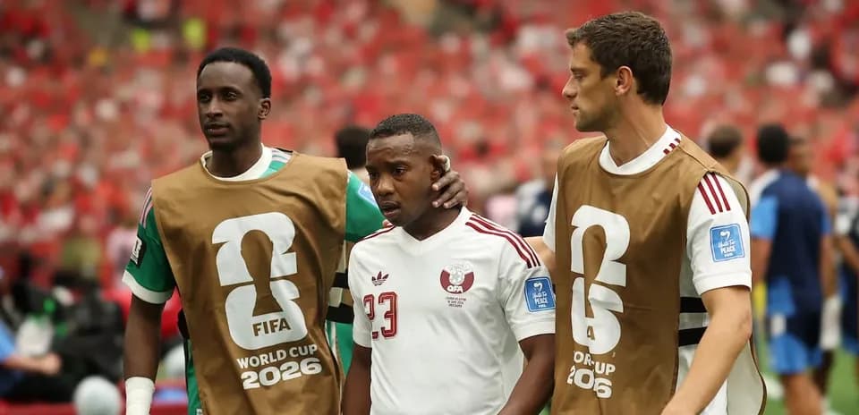 Players assisting teammate off the field during match
