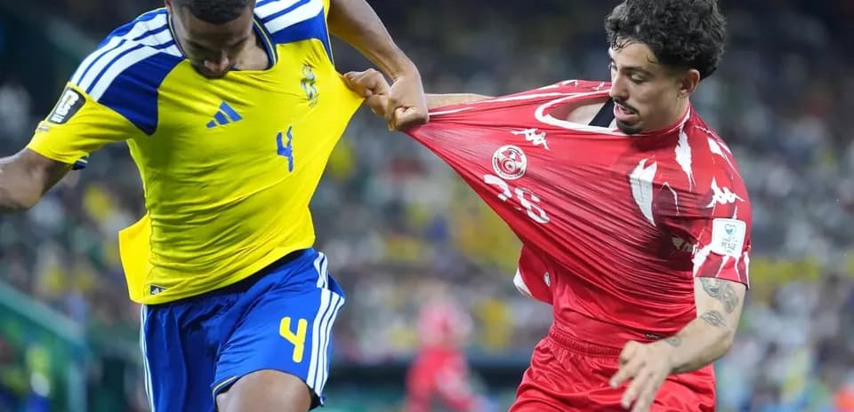 Sweden player challenges Tunisia player during match