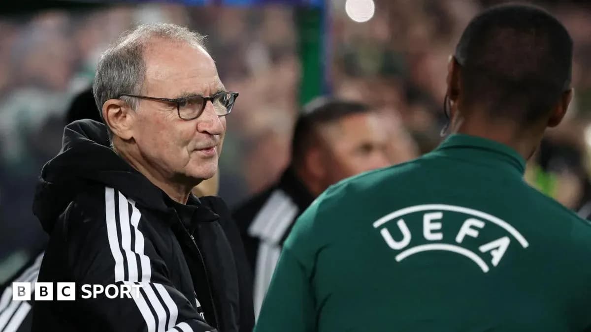 Manager interacting with UEFA official on sidelines