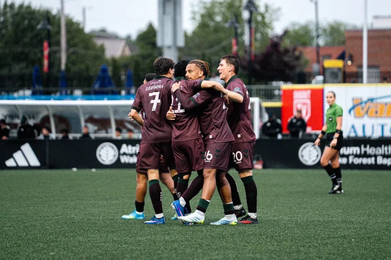 Players celebrating a goal during match