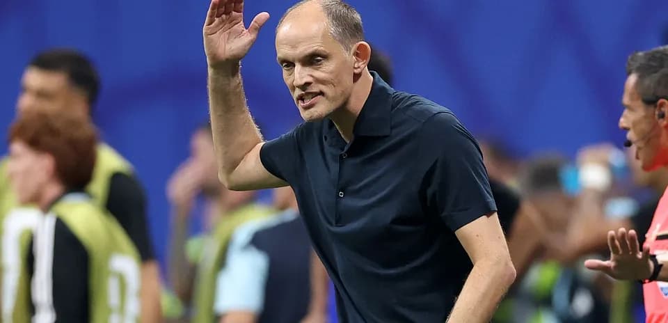 Coach gesturing during a football match on the sidelines