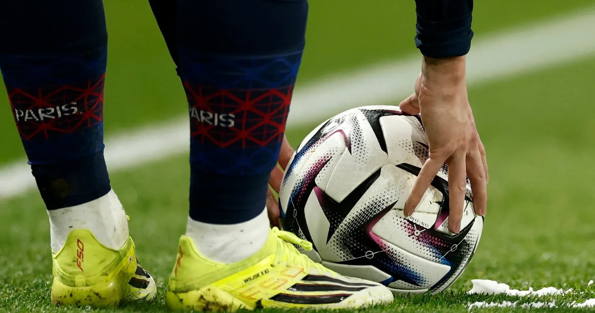 Player placing ball on the pitch for kick
