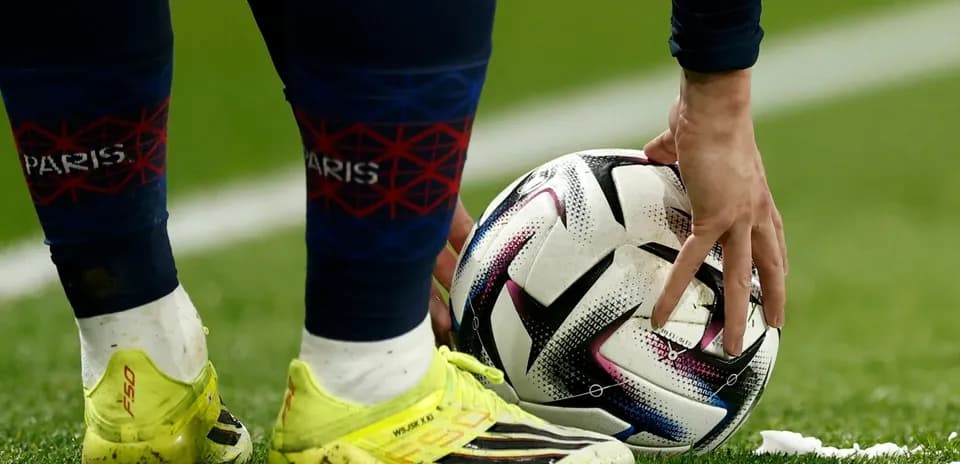 Player placing ball on the pitch for kick