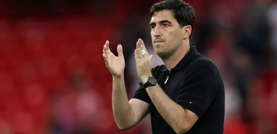 Coach applauding during match with red background