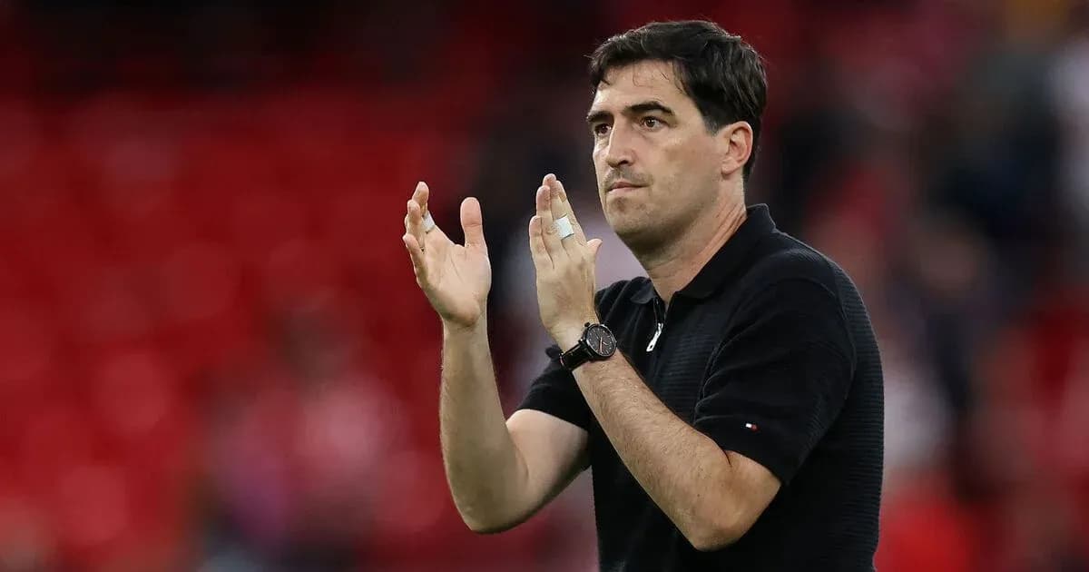 Coach applauding during match with red background