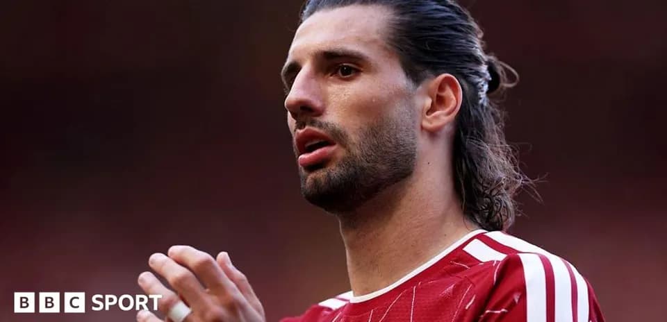 Player in red kit during a match moment