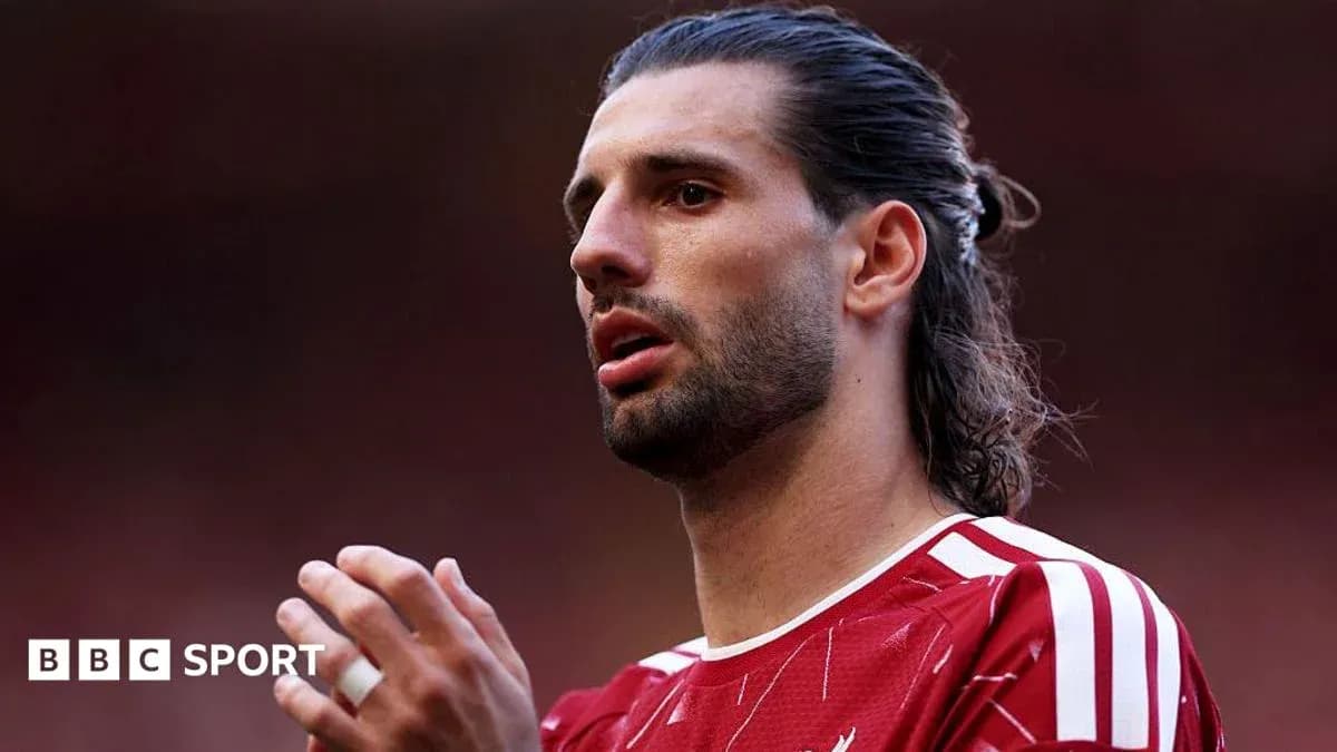 Player in red kit during a match moment