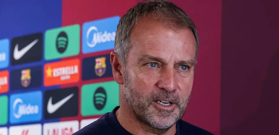 Manager speaking at press conference with club logos