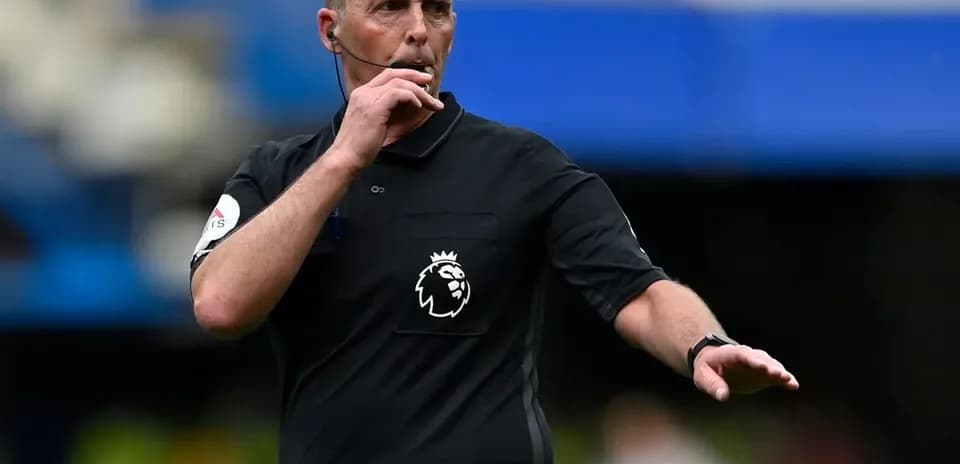 Referee signaling during a Premier League match