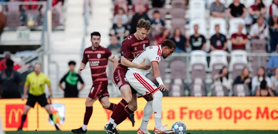 Two players competing for the ball during match