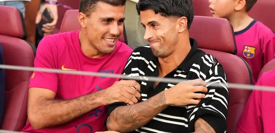 Two players laughing together in stadium seats