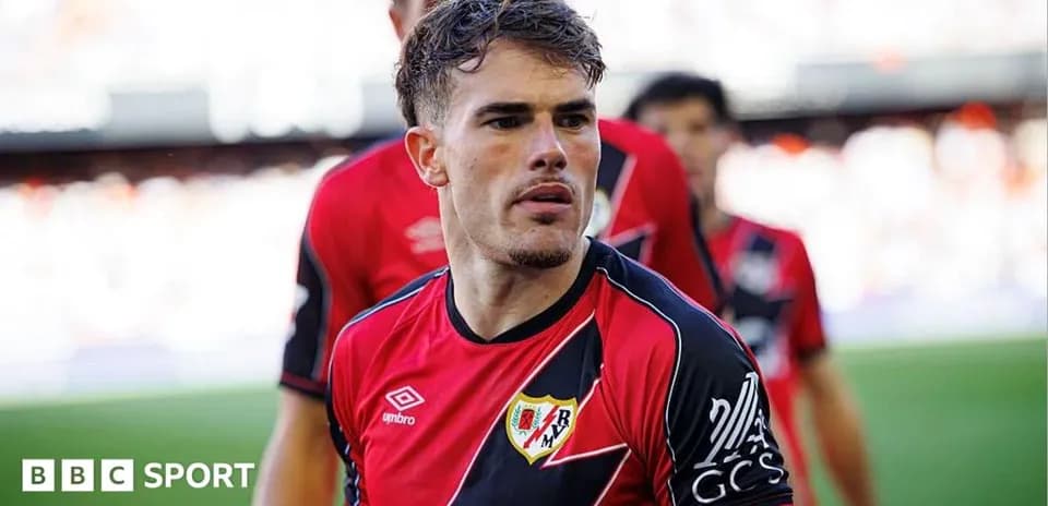 Player in red and black jersey on field