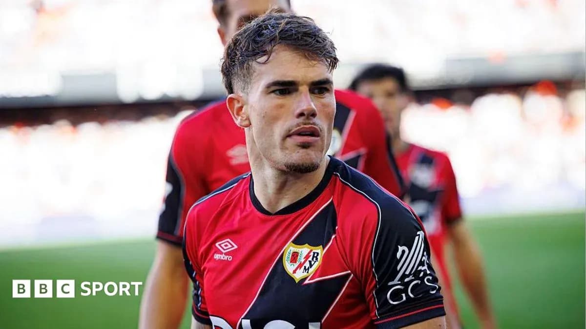 Player in red and black jersey on field