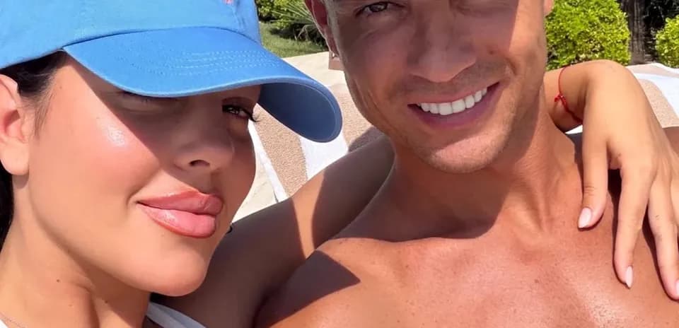 Couple posing for a selfie outdoors in sunlight