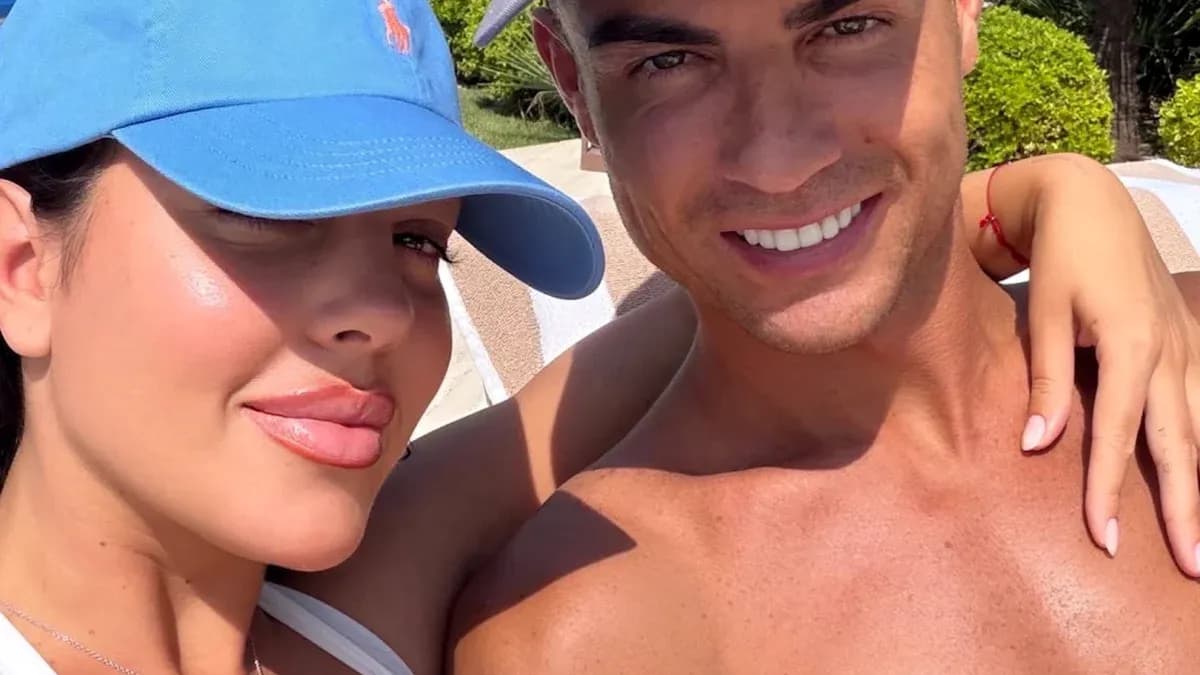 Couple posing for a selfie outdoors in sunlight