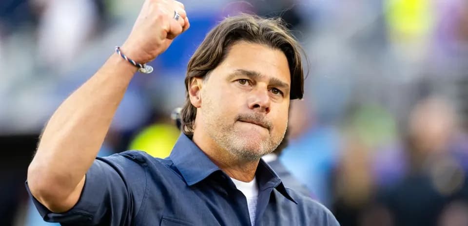 Coach celebrating with raised fist on field