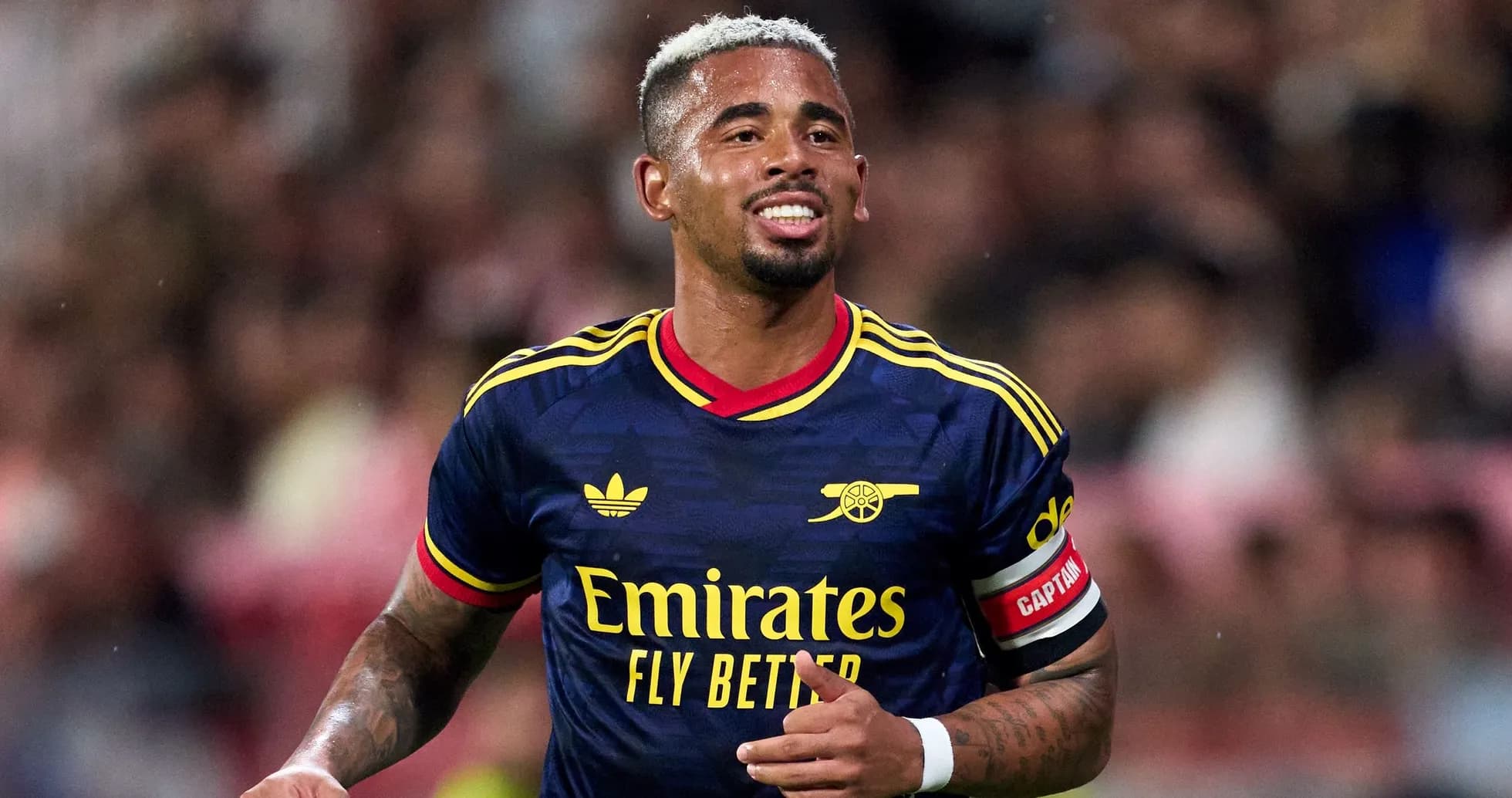 Player celebrating in Arsenal jersey during match