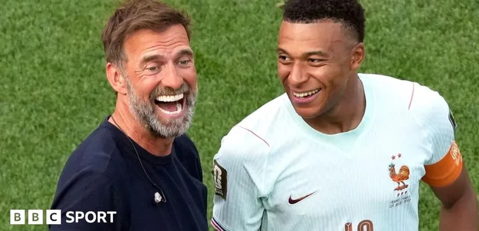 Coach and player smiling on the field