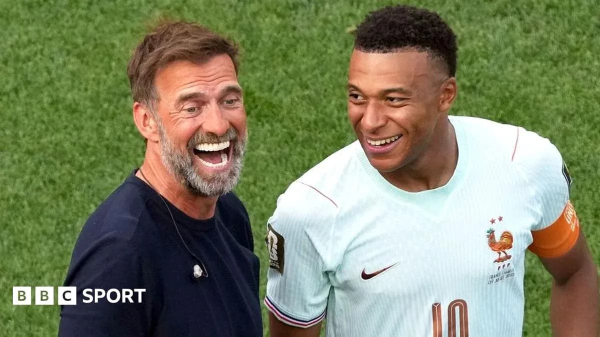 Coach and player smiling on the field