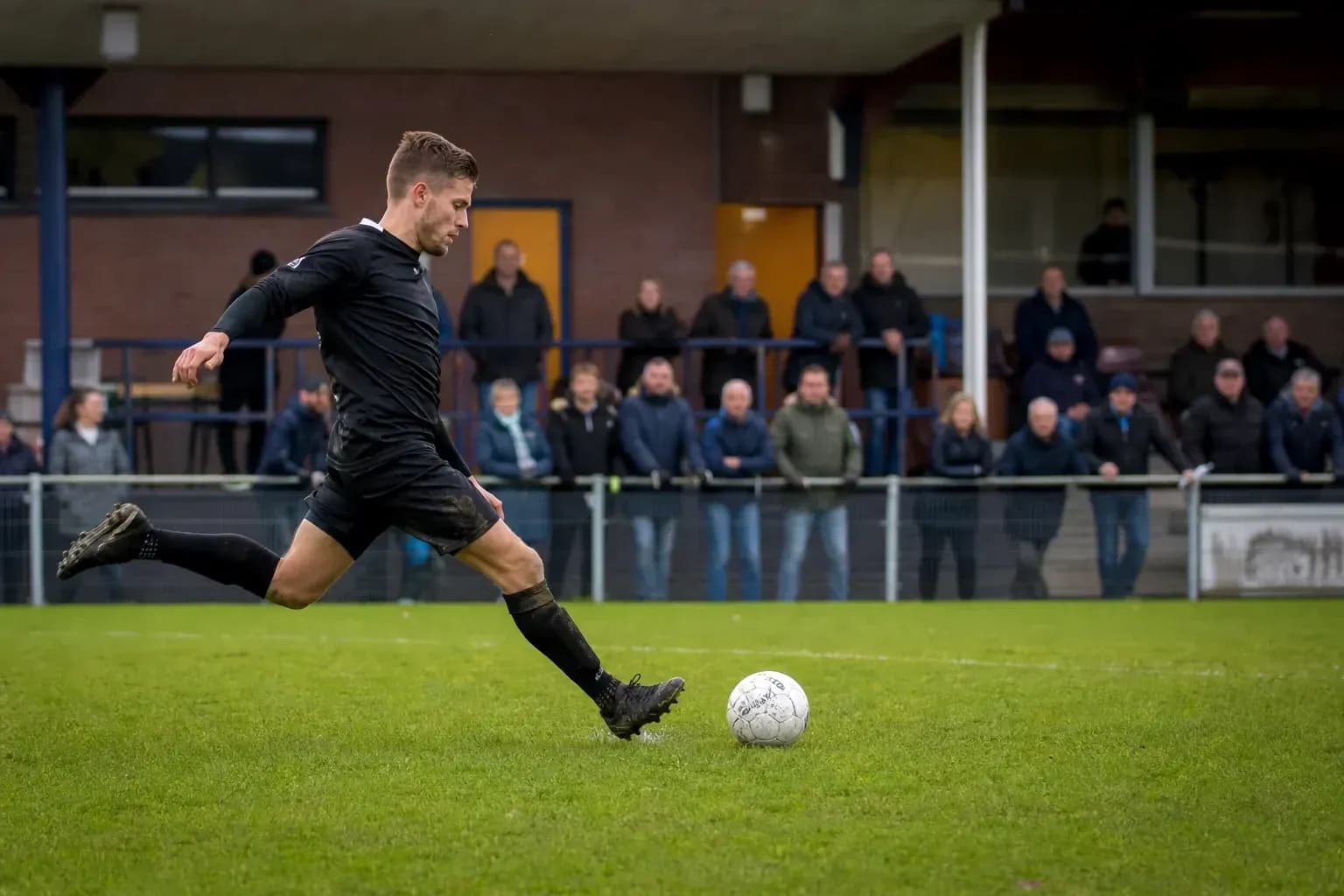 Player kicking a soccer ball on the field