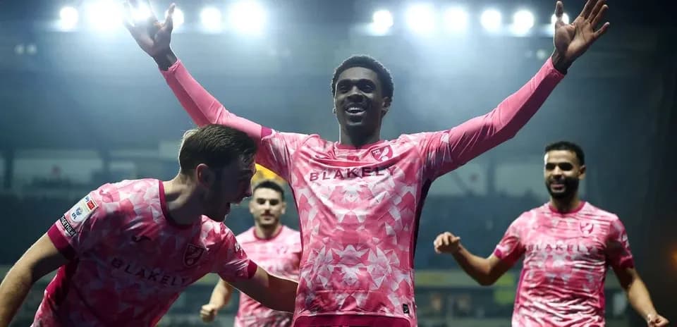 Players celebrating a goal with raised arms