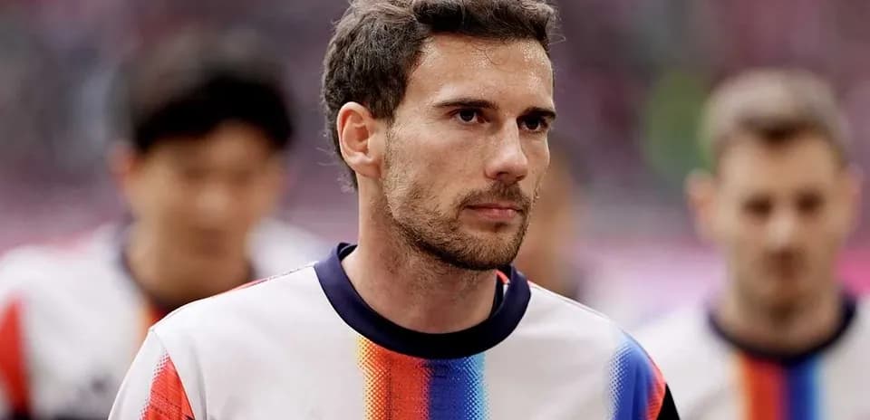 Player walking onto the pitch in team uniform