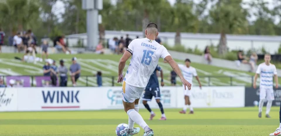 Player Edwards preparing to take a free kick