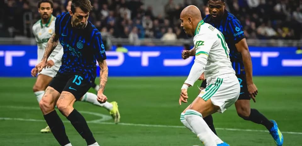Inter player defending against AS Roma attacker